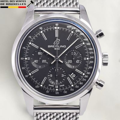 the watch is black and has a stainless steel band