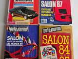 four magazines of different cars are sitting on a table