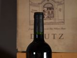 a bottle of wine sitting on a table next to a bottle of wine