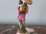 a figurine of a woman carrying a child on her back