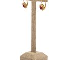 a close up of a pair of earrings on a stand