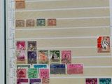 an open book with stamps on it sitting on a wooden table