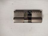 a close up of a metal lock on a white surface
