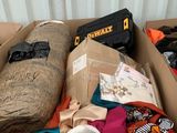 a cardboard box filled with clothes and other items