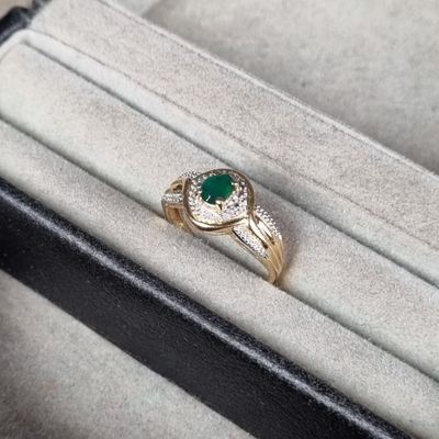 l'image d'une bague contenant une pierre verte
