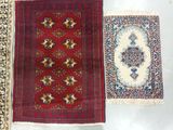 three oriental rugs are laid out on a white surface