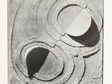 black and white photograph of a sculpture with a circular design on it