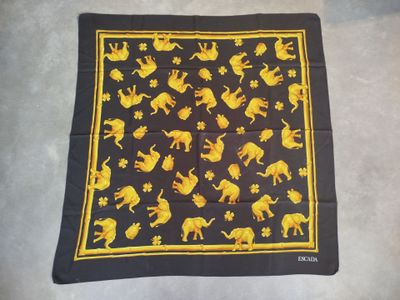 a black and yellow scarf with yellow elephants on it