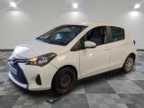 the white toyota yaris is parked on a checkered floor
