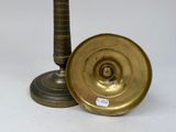 pair of brass candlesticks and a brass plate on a white background