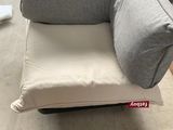 a couch that has a pillow on top of it