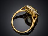 a close up of a gold ring with a pearl and diamonds