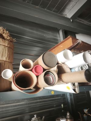 many rolls of toilet paper on a shelf next to a basket
