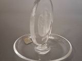 a clear glass object on a plate on a table