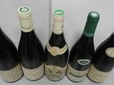 several bottles of wine are lined up on a table