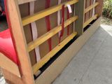 a couch made out of a box with a red seat