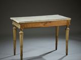 an old wooden table with a marble top on a gray surface