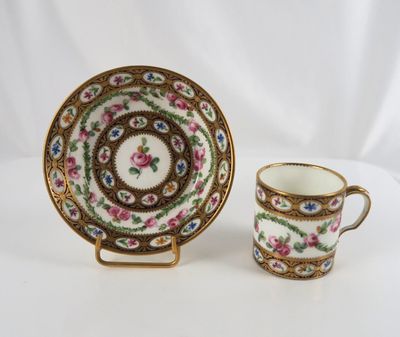 a close up of a cup and saucer on a table