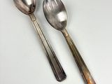 two spoons and a spoon on a white table