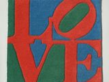 red, green, and blue love sign on a white surface