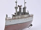 a small model of a boat on a white surface