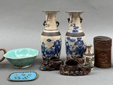 many different vases and bowls sitting on a table
