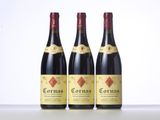 three bottles of red wine sitting on top of a table