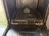 an open oven with the door open and a pan in it