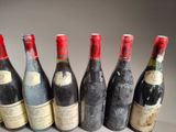 six bottles of wine are lined up in a row on a table