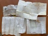 several pieces of paper sitting on top of a table next to a pair of scissors