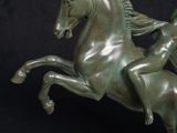 a statue of a man riding a horse on a marble base