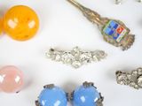 many different types of jewelry on a white surface