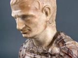 marble bust of a man wearing a red and white marble dress