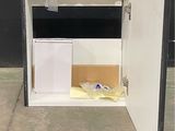 a small cabinet with a door open on the sidewalk