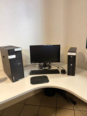 a computer desk with a monitor, keyboard, mouse and monitor on it