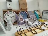 many different clocks on a table with pictures on it