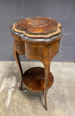 an image of a wooden table with a marble top on a concrete floor