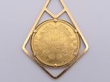 a close up of a gold coin in a diamond shaped pendant