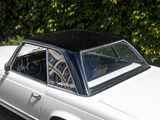 an image of a white car parked on the side of the road