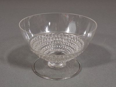 a clear glass bowl with beads in it on a table