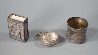 three pieces of silverware including a book, a cup, and a spoon