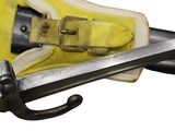 a pair of yellow shoes with a sword in the middle