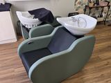 a picture of a hair salon with a sink and a chair