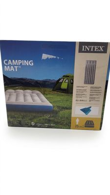 the inflatable mattress is in the box on the grass
