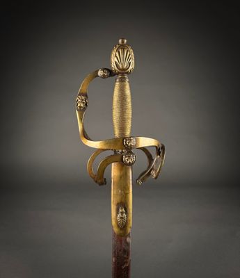 an old sword with a gold handle and a wooden handle