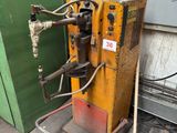 a machine that is sitting next to a green wall