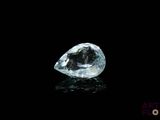 a close up of a white diamond on a black surface