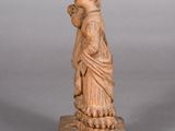 statue of a woman with a hat on her head holding a vase