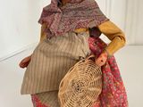 doll of a woman with a basket in her hand