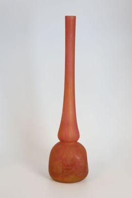 a red vase that is sitting on a white surface